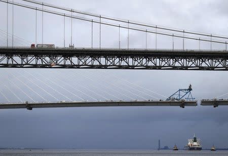 The tanker carrying the first shipment of U.S. shale gas passes the existing road bridge and the new crossing under construction as as it travels up the Forth to dock at Grangemouth in Scotland, Britain September 27, 2016. REUTERS/Russell Cheyne