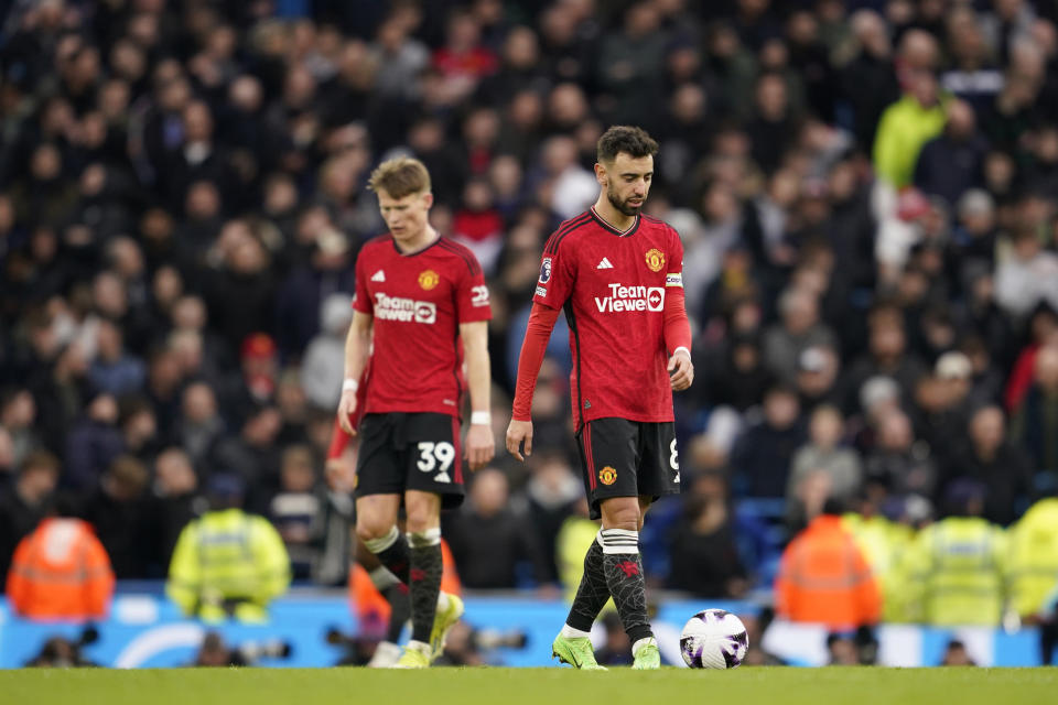Manchester United's Scott McTominay, left and Manchester United's Bruno Fernandes react after Manchester City's Phil Foden scored his side's second goal during an English Premier League soccer match between Manchester City and Manchester United at the Etihad Stadium in Manchester, England, Sunday, March 3, 2024. (AP Photo/Dave Thompson)