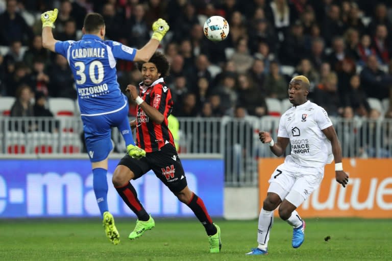 Caen's Yann Karamoh (R) scores a goal against Nice on March 10, 2017 at the Allianz Riviera stadium in Nice, southeastern France