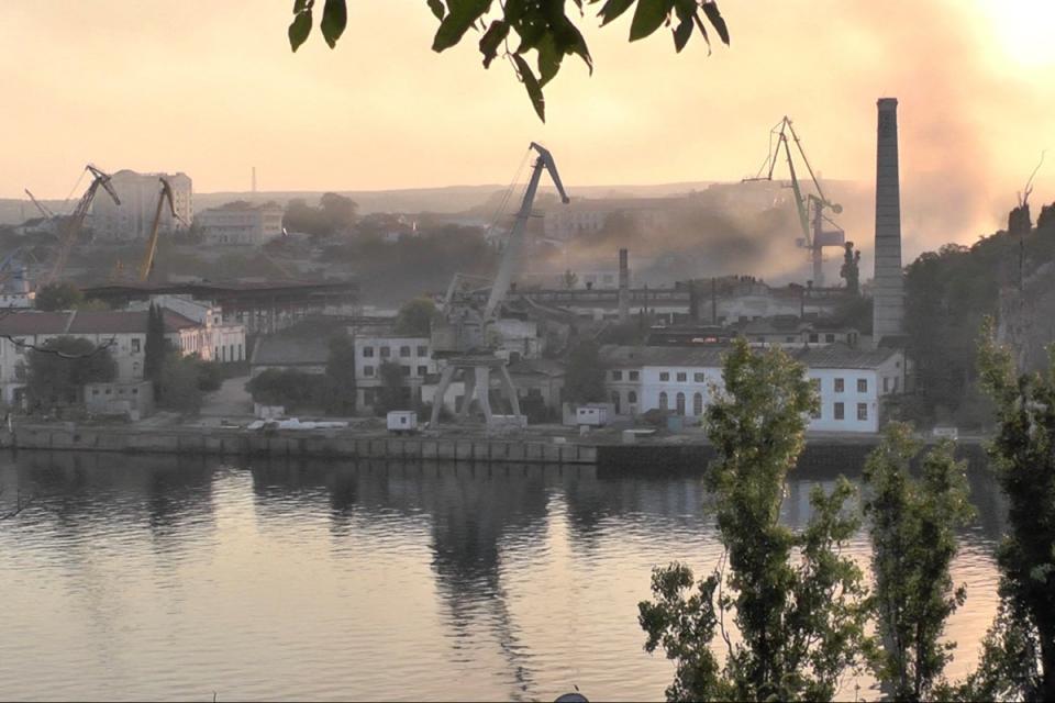 Smoke rises from the shipyard hit by Ukrainian missile attack in Sevastopol (Reuters)