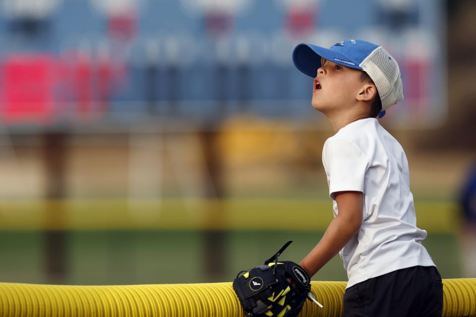 A young fan watches a Cape Cod League baseball game between the Chatham Anglers and the Bourne Braves, Wednesday, July 12, 2023, in Bourne, Mass. For 100 years, the Cape Cod League has given top college players the opportunity to hone their skills and show off for scouts while facing other top talent from around the country. (AP Photo/Michael Dwyer)