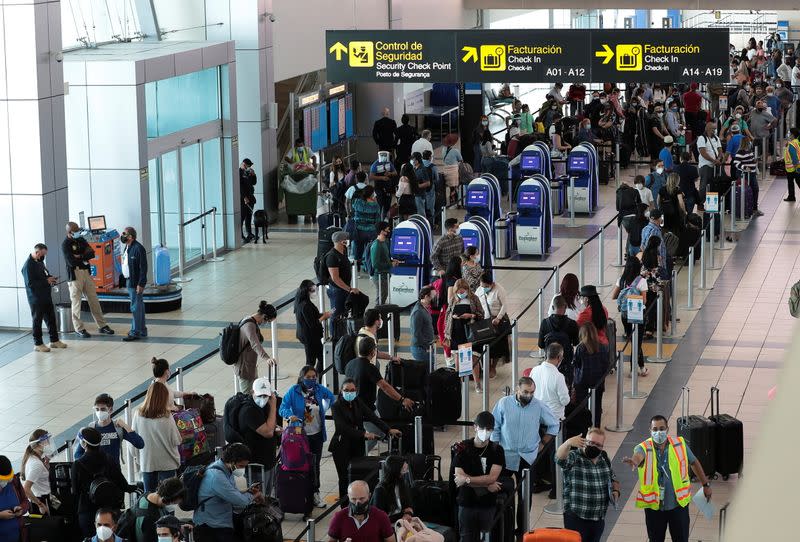 Passengers stand in line at the Tocumen International Airport during the coronavirus disease (COVID-19) outbreak, in Panama City