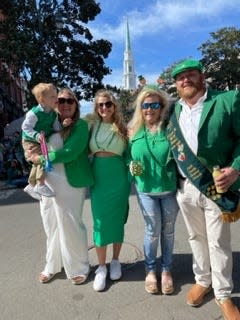 Mary Wooten (green dress) poses for a photo near Wright Square.