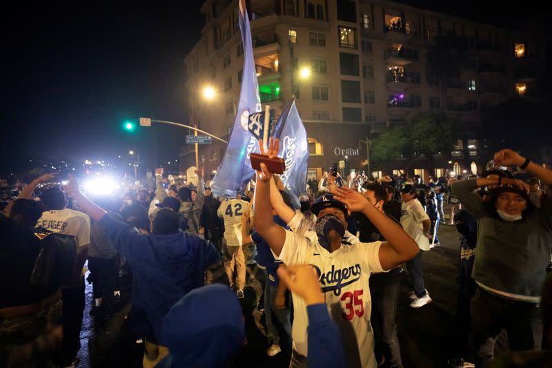 People celebrate Los Angeles Dodgers' victory at the end of game 6 of the 2020 World Series between Los Angeles Dodgers and Tampa Bay Rays, amidst the outbreak of the coronavirus disease (COVID-19), in Los Angeles