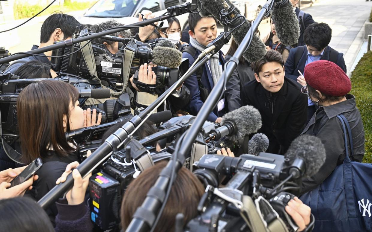 A Kobayashi Pharmaceutical shareholder speaks to reporters in Osaka on Thursday