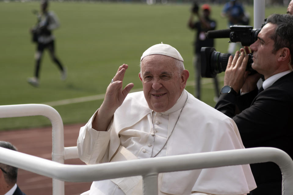 Pope Francis waves at worshipers at the Martyrs’ Stadium in Kinshasa, Congo, Thursday Feb. 2, 2023. Pope Francis urged Congo’s young people to work for a peaceful and honest future on Thursday, getting a raucous response from a generation that has been particularly hard-hit by the country’s chronic poverty, corruption and conflict. (AP Photo/Samy Ntumba Shambuyi)