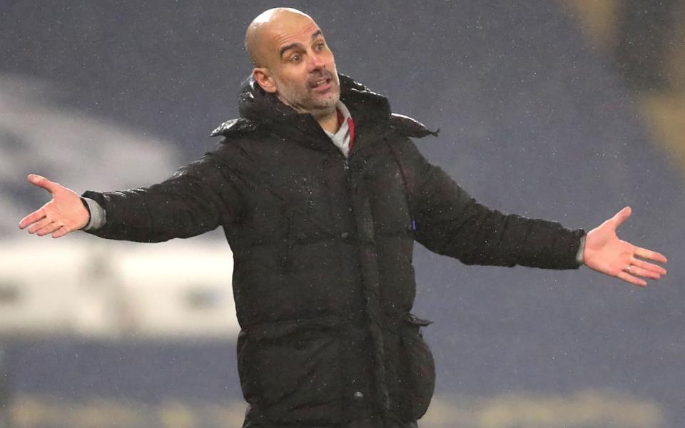 Pep Guardiola gestures to his players from the sidelines - AFP