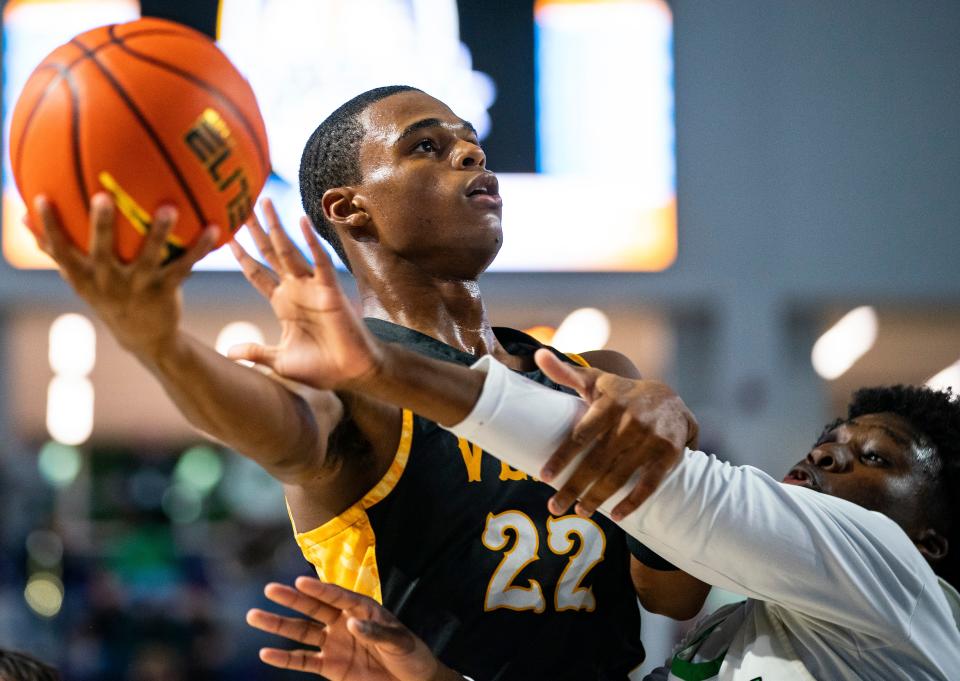 Bishop Verot Vikings guard Leroy Roker (22) goes for a lay up during the fourth quarter of the Hugh Thimlar tribute game against the Bishop Verot Vikings during the 50th annual City of Palms Classic at Suncoast Credit Union Arena in Fort Myers on Wednesday, Dec. 20, 2023.