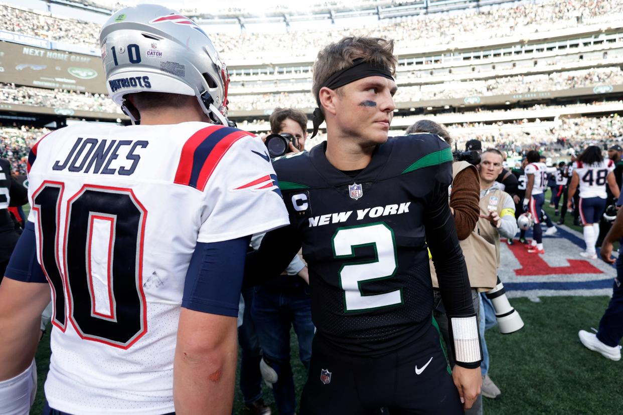 New York Jets quarterback Zach Wilson (2) shakes hands with New England Patriots quarterback Mac Jones (10) after an NFL football game on Sunday, Oct. 30, 2022, in East Rutherford, N.J. (AP Photo/Adam Hunger) ORG XMIT: NYOTK