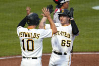 Pittsburgh Pirates' Jack Suwinski (65) is greeted by Bryan Reynolds after hitting a two-run home run off New York Yankees starting pitcher Jameson Taillon during the fourth inning of a baseball game in Pittsburgh, Tuesday, July 5, 2022. (AP Photo/Gene J. Puskar)