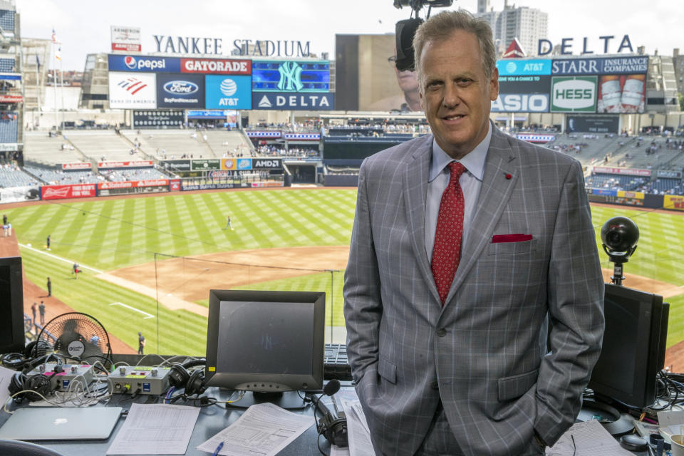 FILE - Michael Kay, YES Network announcer, poses for a portrait in the broadcast booth before a baseball game between the New York Yankees and the Cleveland Indians, Saturday, Aug. 17, 2019, in New York. Baseball players and managers aren’t the only ones who have had to adapt to the various rule changes in Major League Baseball. Radio and television announcers have used spring training and will use the first two weeks of the season to adapt. (AP Photo/Mary Altaffer, File)