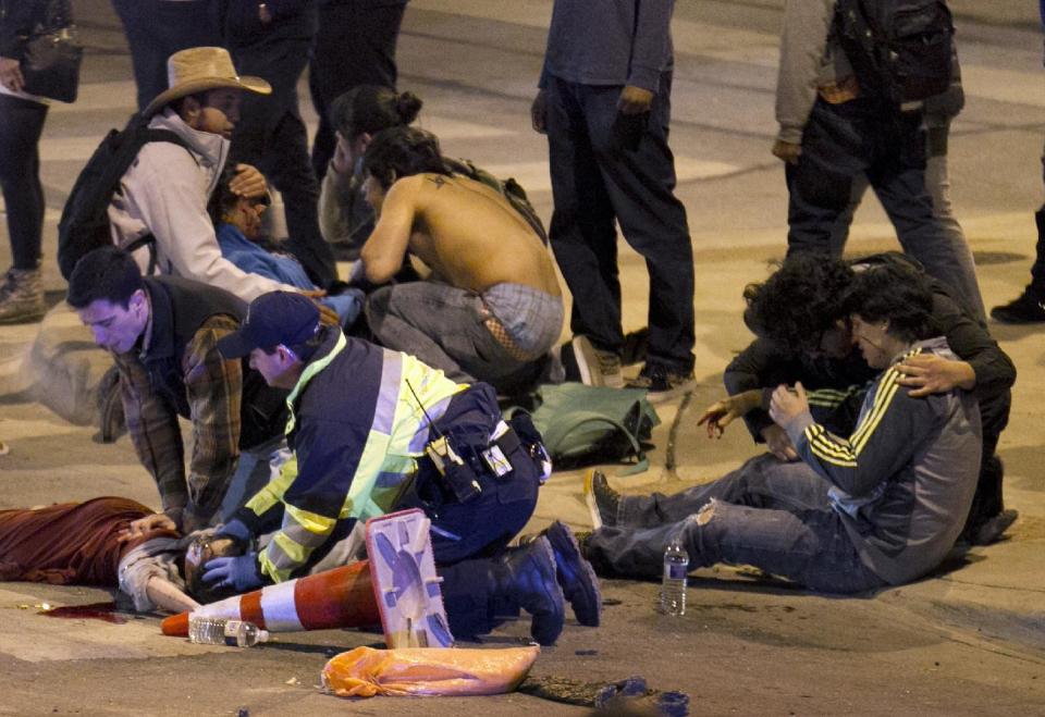 People are treated after being struck by a vehicle on Red River Street in downtown Austin, Texas, on Wednesday March 12, 2014. Police say two people were confirmed dead at the scene after a car drove through temporary barricades set up for the South By Southwest festival and struck a crowd of pedestrians. The condition of the victims shown is unknown. (AP Photo/Austin American-Statesman, Jay Janner) AUSTIN CHRONICLE OUT, COMMUNITY IMPACT OUT, MAGS OUT; NO SALES; INTERNET AND TV MUST CREDIT PHOTOGRAPHER AND STATESMAN.COM