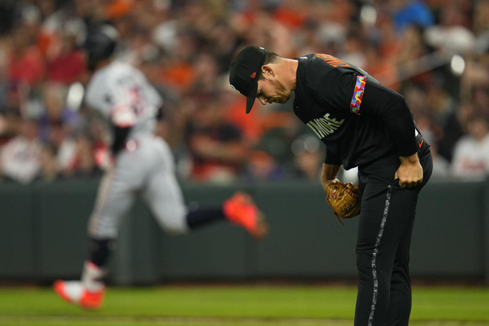 Baltimore Orioles relief pitcher Bruce Zimmermann, right, reacts as Minnesota Twins' Byron Buxton runs the bases after hitting a three-run home run off him during the fourth inning of a baseball game, Friday, June 30, 2023, in Baltimore. Twins' Joey Gallo and Carlos Correa scored on the home run. (AP Photo/Julio Cortez)