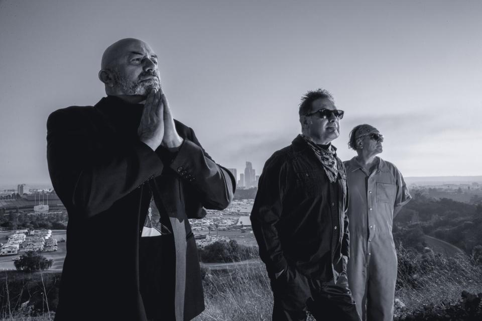 Three men standing on a hilltop