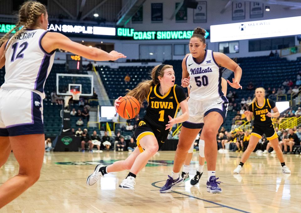 Iowa guard Molly Davis drives to the basket as Kansas State center Ayoka Lee defends during their game in the Gulf Coast Showcase championship game on Nov. 26.