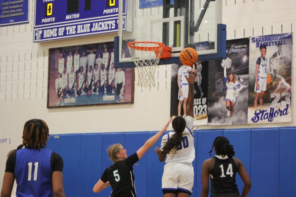 Janiyah Heyward of Woodville-Tompkins finishes inside against Veronica Sierzant in the Savannah Senior Showcase Wednesday night.