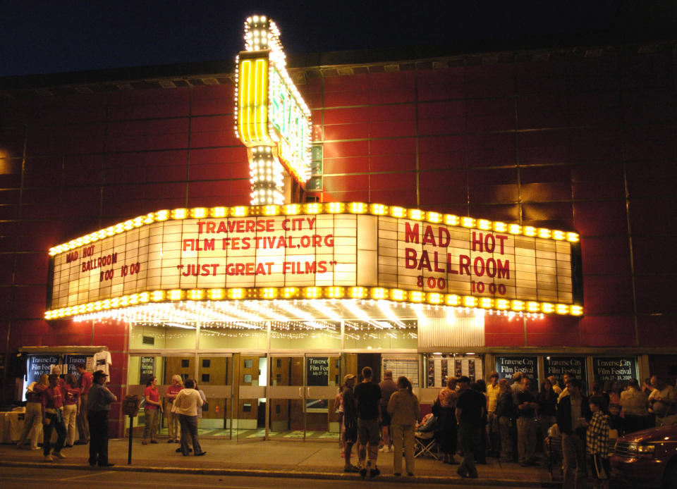 FILE - This July 27, 2005 file photo shows the inaugural Traverse City Film Festival in the renovated State Theatre in downtown Traverse City, Mich. The Traverse City Film Festival, co-founded by filmmaker and Michigan native Michael Moore, runs from July 30 to Aug. 4. It features foreign, independent and documentary movies, with tickets for most showings costing $10. But it also has free attractions, including nightly classics shown on a giant inflatable screen by the waterfront and panel discussions with guest directors and producers. (AP Photo/John L. Russell, file)