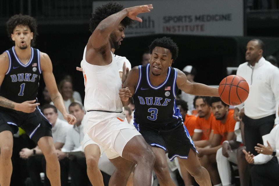 Miami forward Norchad Omier (15) defends Duke guard Jeremy Roach (3) during the first half of an NCAA college basketball game, Monday, Feb. 6, 2023, in Coral Gables, Fla. (AP Photo/Marta Lavandier)