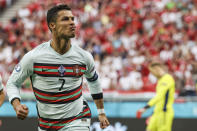 FILE - In this Tuesday, June 15, 2021 file photo Portugal's Cristiano Ronaldo celebrates after scoring his second team goal during the Euro 2020 soccer championship group F match between Hungary and Portugal at the Ferenc Puskas stadium in Budapest, Hungary. Video from the game showed Hungarian fans chanting "Cristiano homosexual!" at Portuguese captain Cristiano Ronaldo during the match. In 2017, FIFA, soccer's international governing body, fined the Hungarian Football Federation $22,000 after Hungarian fans directed the same chant at Ronaldo at a World Cup qualifier in Budapest. (Bernadett Szabo/Pool via AP, File)