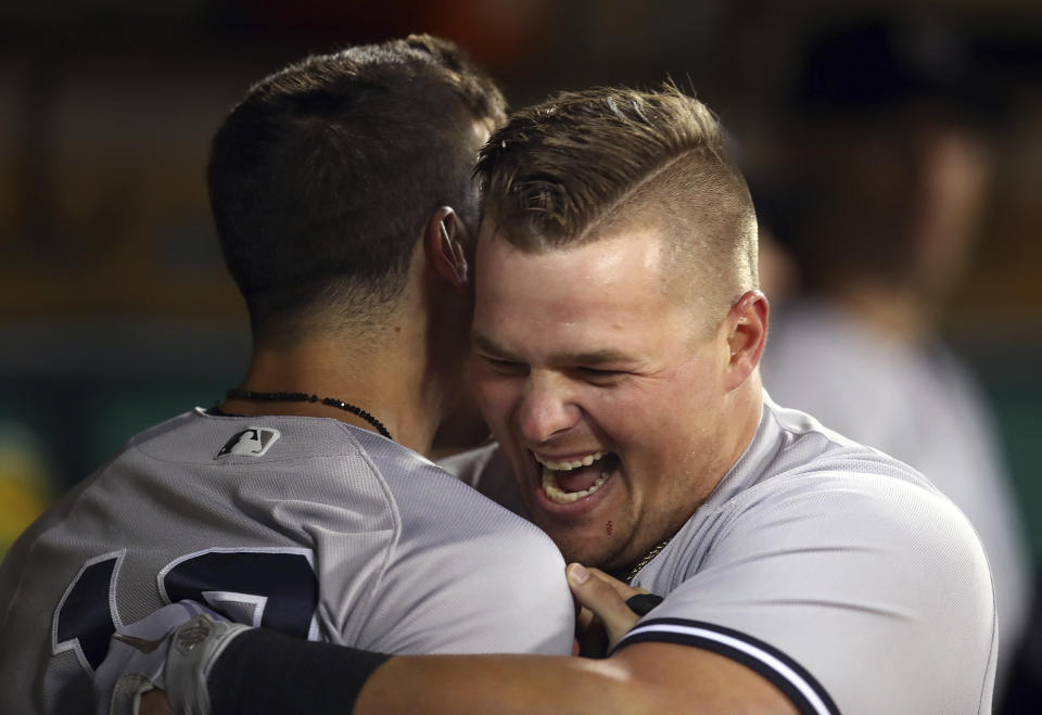 New York Yankees' Luke Voit, right, celebrates with Tyler Wade after hitting a home run off Oakland Athletics' Fernando Rodney during the eighth inning of a baseball game Tuesday, Sept. 4, 2018, in Oakland, Calif. (AP Photo/Ben Margot)