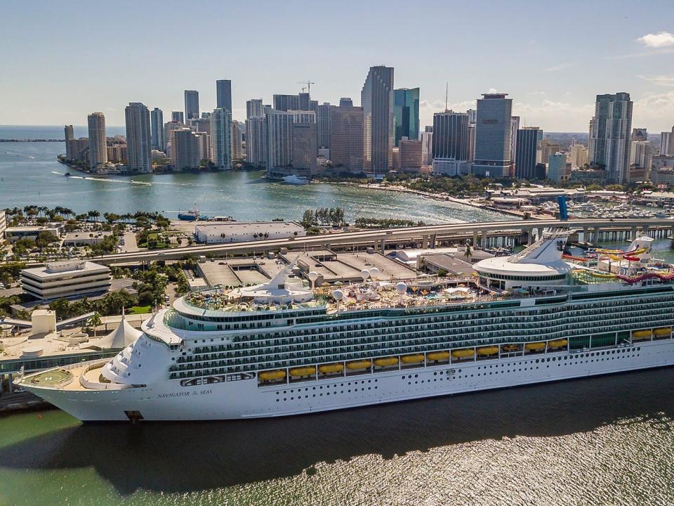 Royal Caribbean's newly renovated Navigator of the Seas docks at Port Miami on March 1, 2019, with a skyline behind it.