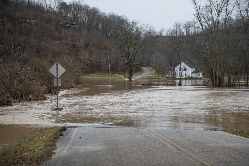 CORRECTS TO SCOTTOWN, OHIO, NOT W.VA. - High water from the flooded Indian Guyan Creek covers Pleasant Ridge Road on Friday, Feb. 17, 2023, in Scottown. Ohio. (Sholten Singer/The Herald-Dispatch via AP)