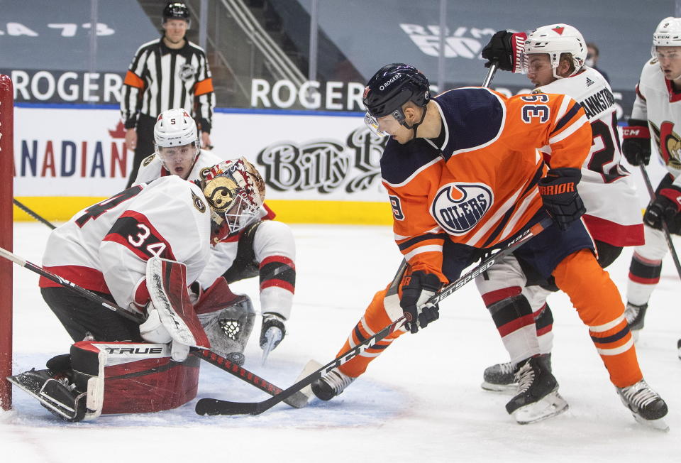 Edmonton Oilers' Alex Chiasson (39) is stopped by Ottawa Senators goalie Joey Daccord (34) during second-period NHL hockey game action in Edmonton, Alberta, Monday, March 8, 2021. (Jason Franson/The Canadian Press via AP)