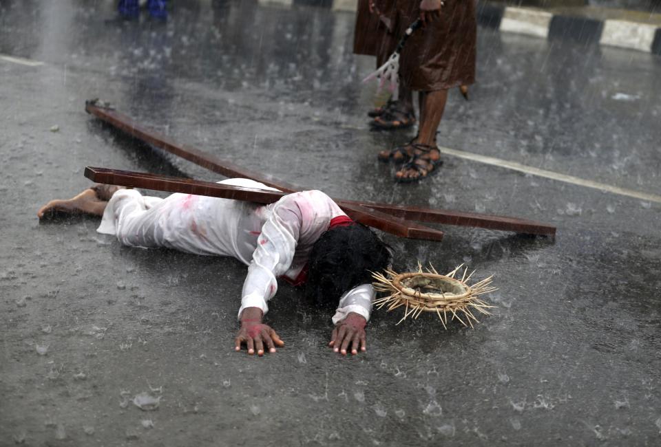 A man dressed as Jesus Christ performs during a re-enactment of the death of Jesus Christ, on Good Friday in Lagos