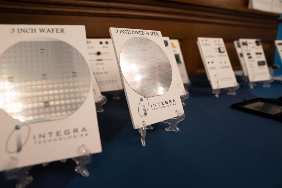 Examples of the semiconductor chips manufactured by Integra Technologies are displayed during Thursday's announcement at the Statehouse.