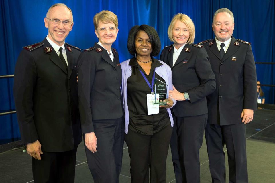 <p>The Salvation Army of Greater Charlotte</p> Deronda Metz (center)  receiving a national award for her social services work at the 2023 national Salvation Army conference