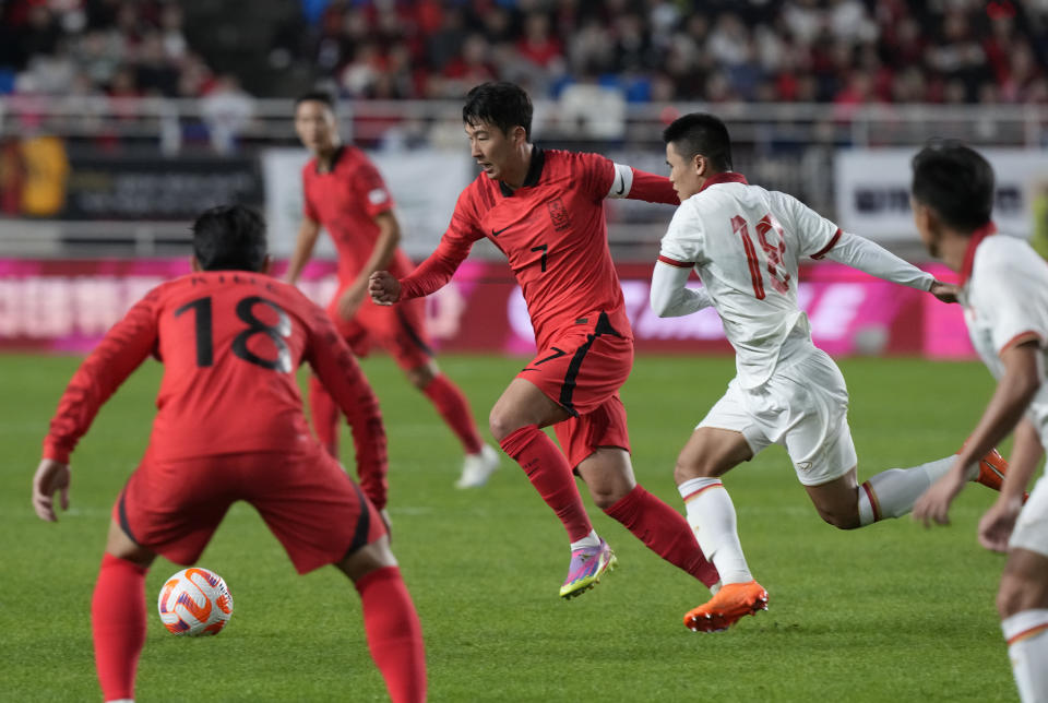 South Korea's Son Heung-min, center left, fights for the ball against Vietnam's Pham Tuan Hai during an international friendly soccer match in Suwon, South Korea, Tuesday, Oct. 17, 2023. (AP Photo/Ahn Young-joon).