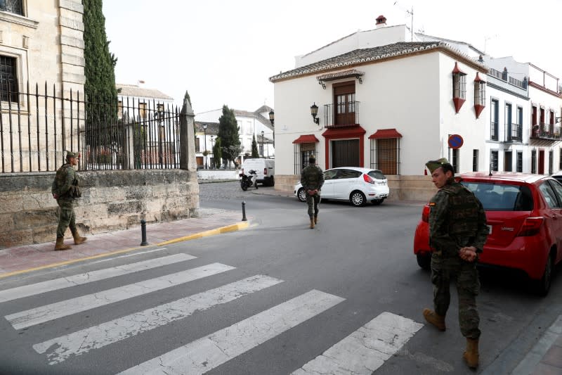 Spanish legionnaires patrol in an empty street in downtown Ronda