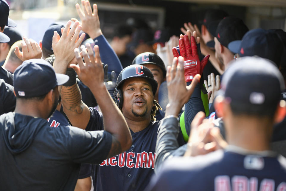 Cleveland Guardians' Jose Ramirez celebrates in the dugout after scoring on a Kole Calhoun three-run home run during the tenth inning of a baseball game Wednesday, Aug. 30, 2023, in Minneapolis. Bo Naylor also scored as the Guardians won 5-2. (AP Photo/Craig Lassig)