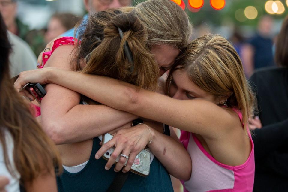 Locals embrace near the scene of the mass shooting (Getty Images)