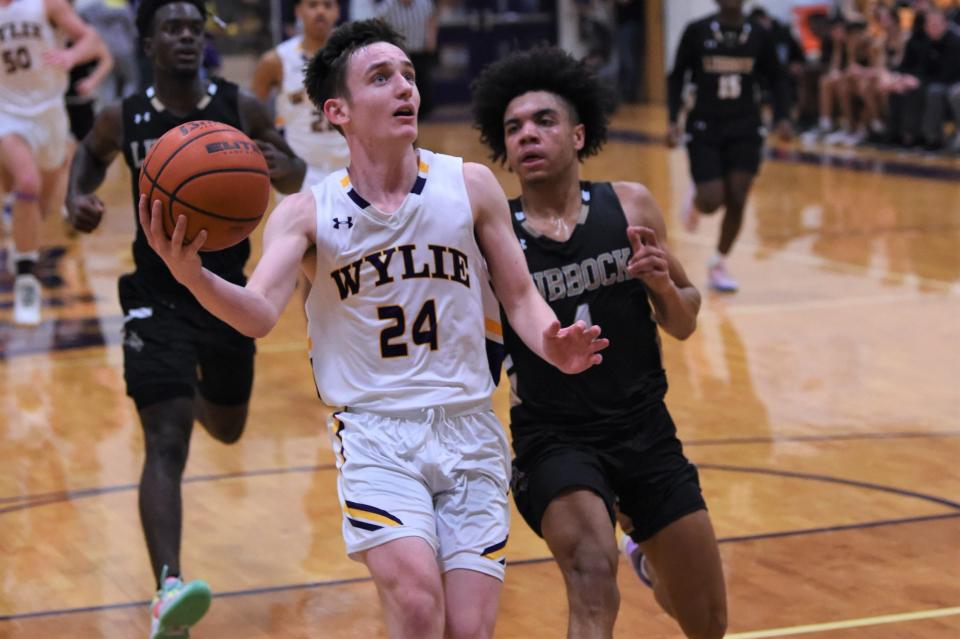 Wylie's Martin Marshall (24) goes up for a layup after a steal during Tuesday's game against Lubbock High at Bulldog Gym. Marshall scored 19 points, including eight in the second quarter of the 66-57 victory.