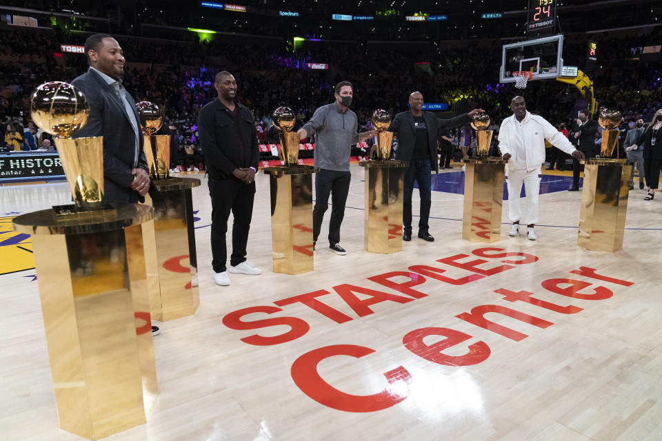 Former NBA players Robert Horry, from left, Metta Sandiford-Artest, Luke Walton, Byron Scott and Gary Payton stand for photos during a ceremony held to say farewell to the name of Staple Center during an NBA basketball game between the Los Angeles Lakers and the San Antonio Spurs Thursday, Dec. 23, 2021, in Los Angeles. Staple Center will officially be renamed Crypto.com Arena on Christmas Day. (AP Photo/Jae C. Hong)