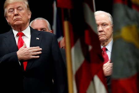 FILE PHOTO: U.S. President Donald Trump and Attorney General Jeff Sessions stand for the national anthem at a graduation ceremony at the FBI Academy on the grounds of Marine Corps Base Quantico in Quantico, Virginia, U.S. December 15, 2017. REUTERS/Jonathan Ernst/File Photo