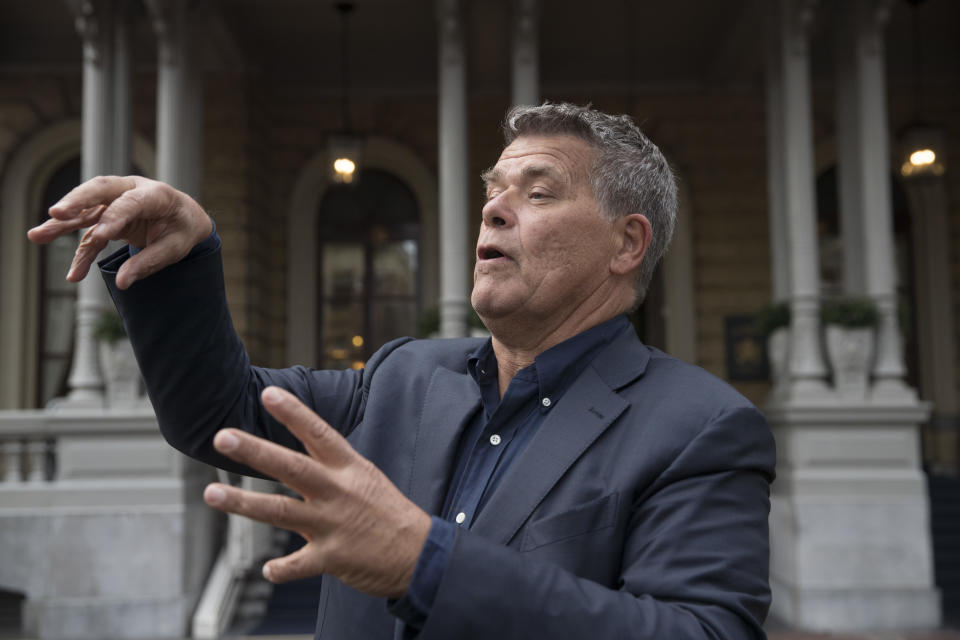 Self-styled Dutch positivity guru Emile Ratelband answers questions during an interview in Amsterdam, Netherlands, Monday, Dec. 3, 2018. A Dutch court has rejected the request of a self-styled positivity guru to shave 20 years off his age, in a case that drew worldwide attention. Emile Ratelband last month asked the court in Arnhem to formally change his date of birth to make him 49, instead of his real age of 69. He argued his request was consistent with other personal transformations, such as the ability to change one's name or gender. The Dutch court said age matters under Dutch law. (AP Photo/Peter Dejong)