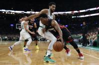 Miami Heat's Kyle Lowry (7) drives past Boston Celtics' Jayson Tatum during the first half of Game 3 of the NBA basketball playoffs Eastern Conference finals Saturday, May 21, 2022, in Boston. (AP Photo/Michael Dwyer)