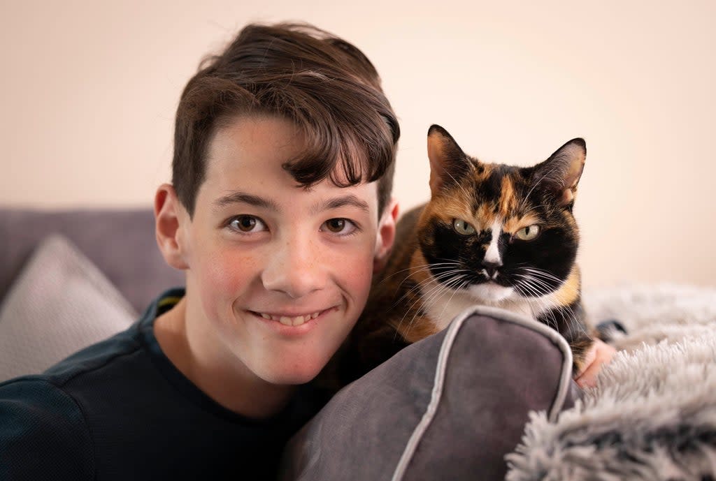 Elliot Abery, 11, from Thatcham, Berkshire, with his pet Chicken, who has been nominated for a National Cat Award (Matt Alexander/PA)