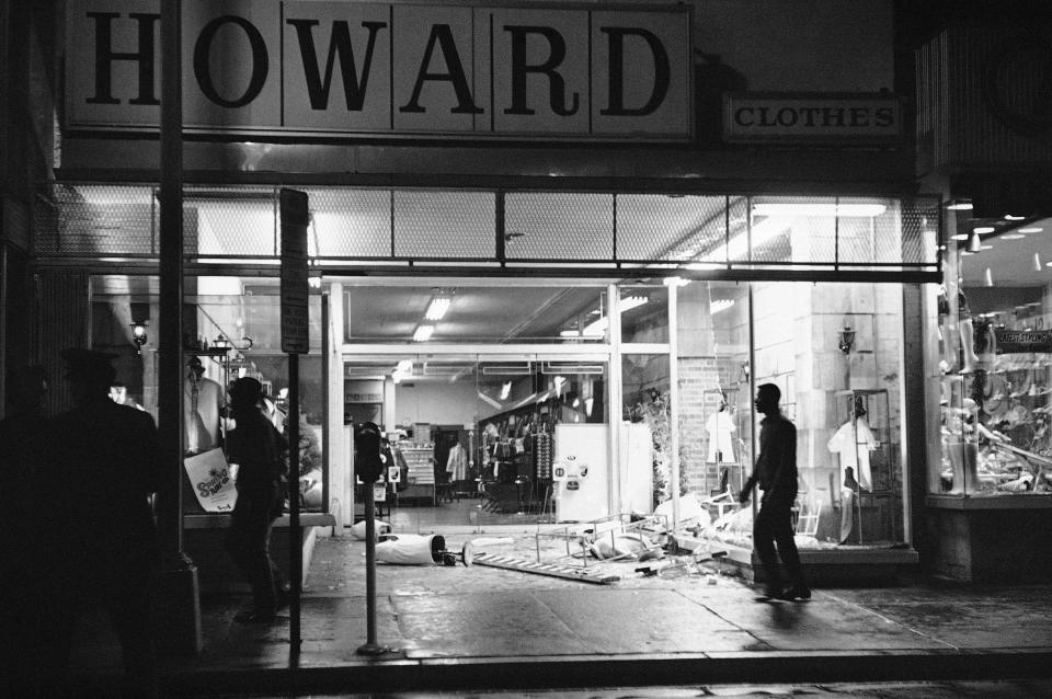 FILE- In this April 4, 1968 file photo, glass and mannequins litter a sidewalk of a clothing store in Northwest Washington after crowds broke into and took items from some stores following the news of Dr. Martin Luther King Jr.'s assassination. (AP Photo/Charles Harrity)