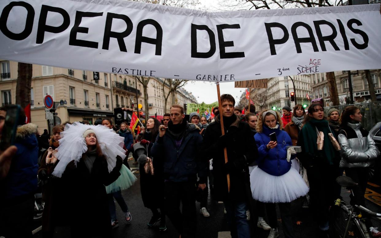 Dancers from the Paris Opera House march during a demonstration on Thursday 12 December - AP