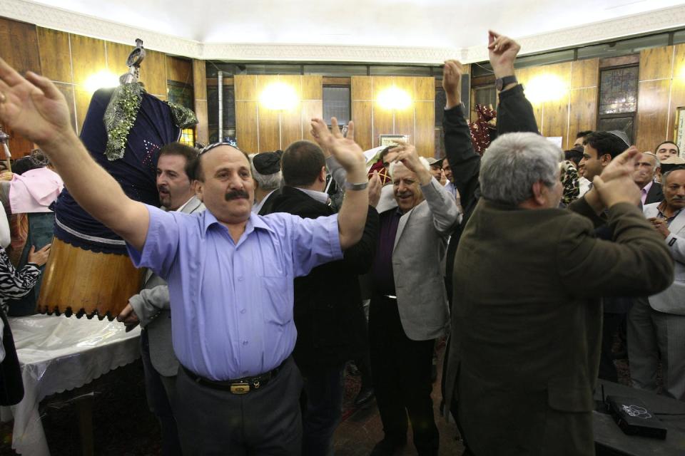 Jewish men in Tehran, Iran, dance during Simchat Torah as one holds the covered Torah scroll. <a href="https://newsroom.ap.org/detail/MideastIranJews/fd340f1bde654da8b3dc389143ca4af6/photo?Query=simchat%20torah&mediaType=photo&sortBy=arrivaldatetime:desc&dateRange=Anytime&totalCount=24&currentItemNo=16" rel="nofollow noopener" target="_blank" data-ylk="slk:AP Photo/Vahid Salemi;elm:context_link;itc:0;sec:content-canvas" class="link ">AP Photo/Vahid Salemi</a>