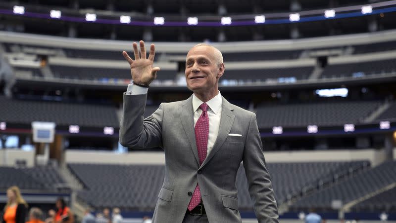 Big 12 Commissioner Brett Yormark indulges a student media outlet with a Baylor Bear hand sign before speaking at the opening of the NCAA college football Big 12 media days in Arlington, Texas, on July 12, 2023.