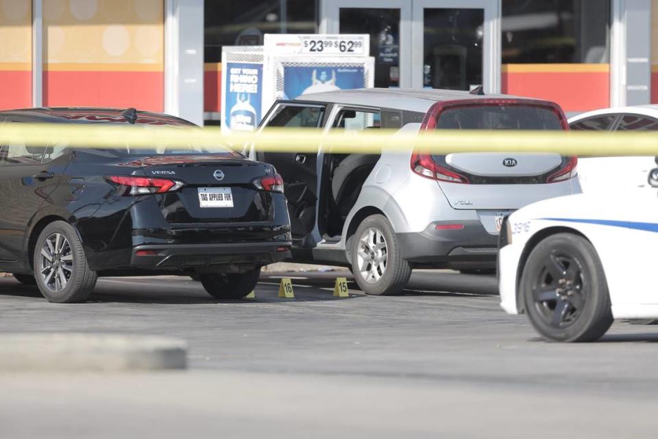 Police crime scene tape and markers seen near a Kia Soul parked at Family Dollar on Pass Road in Gulfport after an offiicer involved shooting on October 6, 2022.