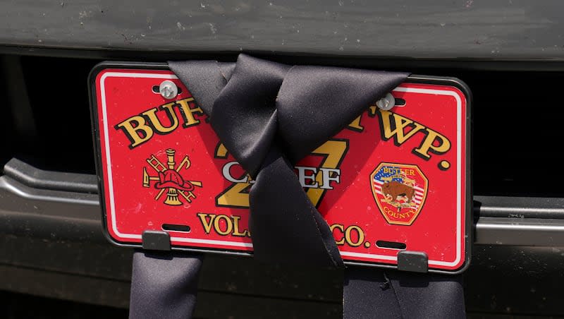 An automobile license plate at the Buffalo Township Fire Company 27 is wrapped in black bunting in Buffalo Township, Pa., Sunday, July 14, 2024. Firefighter Corey Comperatore was killed during a shooting at a campaign rally for Republican presidential candidate former President Donald Trump in Butler, Pa., on Saturday.