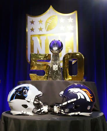 Feb 5, 2016; Santa Clara, CA, USA; A general view of helmets for the Carolina Panthers and Denver Broncos and the Vince Lombardi Trophy with the Super Bowl 50 logo prior to the commissioner's press conference at Moscone Center. Mandatory Credit: Matthew Emmons-USA TODAY Sports