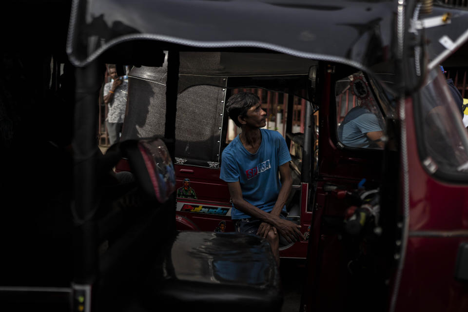 A driver of an autorickshaw waits in queue to buy petrol at a fuel station, in Colombo, Sri Lanka, July 17, 2022. Bankruptcy has forced the island nation's government to a near standstill. Parliament is expected to elect a new leader Wednesday, paving the way for a fresh government, but it is unclear if that's enough to fix a shattered economy and placate a furious nation of 22 million that has grown disillusioned with politicians of all stripes. (AP Photo/Rafiq Maqbool)