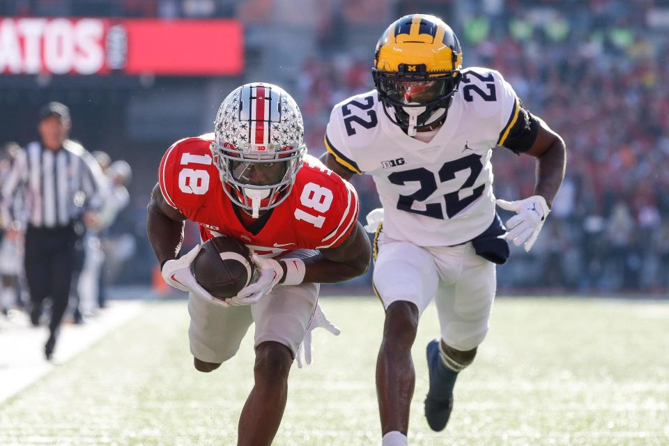 Ohio State wide receiver Marvin Harrison Jr. (18) makes catch against Michigan defensive back Gemon Green during the first half at Ohio Stadium in Columbus, Ohio, on Saturday, Nov. 26, 2022.