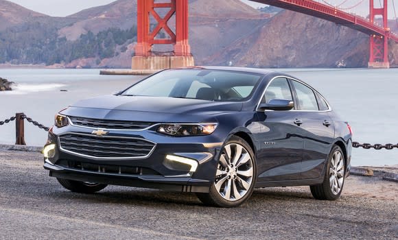 A dark blue Chevrolet Malibu midsize sedan, parked with the Golden Gate Bridge visible in the background.